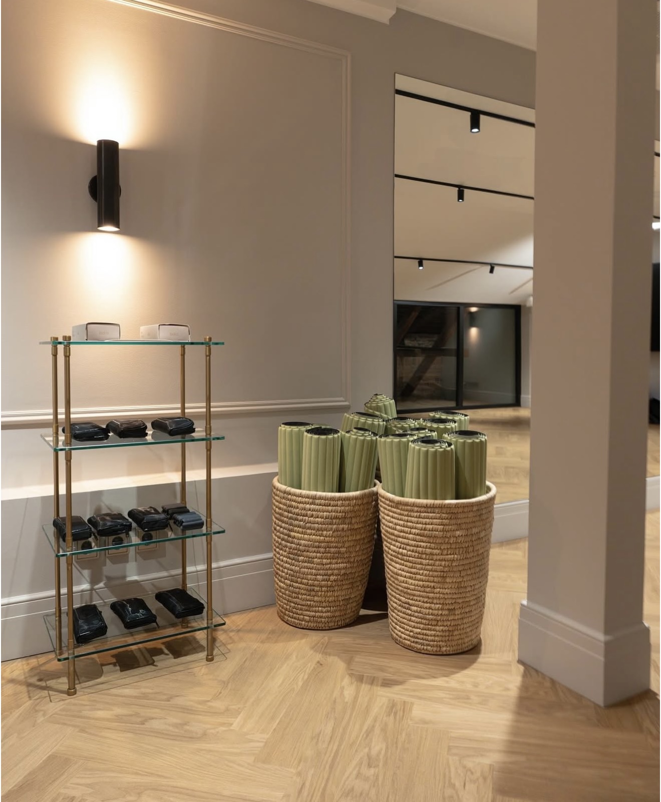 Shelving at The Hotel Maria with folded towels, weights and woven baskets.